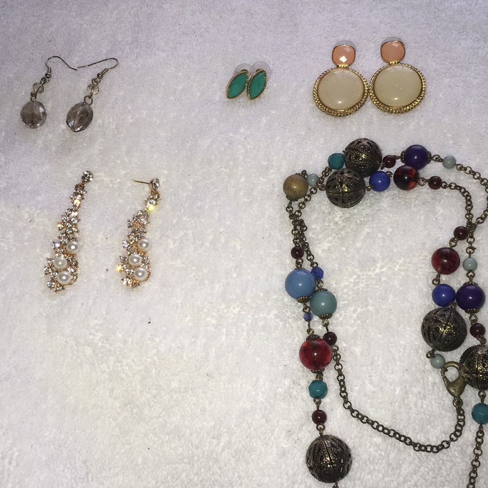 Necklace with a bunch of different earrings
